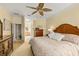 A main bedroom featuring a wooden headboard, neutral decor, and a ceiling fan at 2457 Bar Harbor, Mount Dora, FL 32757