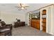 Home office with built-in bookshelves, wooden cabinets, neutral carpet, and comfortable leather seating at 2457 Bar Harbor, Mount Dora, FL 32757