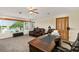 Inviting home office with large desk, waterfront view, comfortable seating, and neutral carpet at 2457 Bar Harbor, Mount Dora, FL 32757