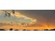 Dramatic sunset view of colorful sky at dusk over distant community at 2457 Bar Harbor, Mount Dora, FL 32757