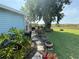 Lush backyard with tropical plants, paved walkway and space for outdoor entertaining at 24841 Pine Hl, Leesburg, FL 34748