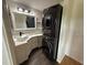 Updated bathroom with modern fixtures and stacked washer and dryer at 24841 Pine Hl, Leesburg, FL 34748