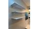 Bathroom view showcasing three mounted white shelves with hardware against the wall, and a mirrored medicine cabinet at 24841 Pine Hl, Leesburg, FL 34748