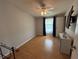 Bedroom featuring wood-look floors, a ceiling fan, and a closet at 24841 Pine Hl, Leesburg, FL 34748