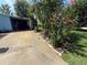 Driveway leading to a covered carport, complemented by flowering plants at 24841 Pine Hl, Leesburg, FL 34748
