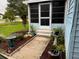 Entrance of the house featuring a screened-in porch and lovely landscaping and bird bath at 24841 Pine Hl, Leesburg, FL 34748