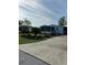 Charming home featuring a blue exterior, screened porch, well-maintained landscaping, and concrete driveway at 24841 Pine Hl, Leesburg, FL 34748
