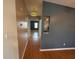 Hallway featuring wood-look flooring, neutral paint, and a decorative hanging light at 24841 Pine Hl, Leesburg, FL 34748