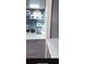 Kitchenette with gray cabinets, white countertops and backsplash, and stainless coffee maker at 24841 Pine Hl, Leesburg, FL 34748