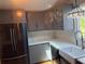 Updated kitchen with stainless steel appliances and stylish gray cabinets at 24841 Pine Hl, Leesburg, FL 34748