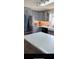 Gray kitchen features stainless steel refrigerator, white countertops, and white tile backsplash at 24841 Pine Hl, Leesburg, FL 34748