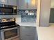 Modern kitchen with stainless steel appliances and custom cabinets at 24841 Pine Hl, Leesburg, FL 34748