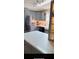 Updated kitchen with gray cabinets and white countertops, features stainless steel refrigerator at 24841 Pine Hl, Leesburg, FL 34748