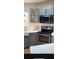 Kitchen boasts stainless steel appliances, gray cabinets, and white countertops at 24841 Pine Hl, Leesburg, FL 34748
