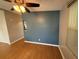 Spacious living room featuring wood floors and a modern ceiling fan at 24841 Pine Hl, Leesburg, FL 34748