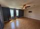 Spacious living room with a ceiling fan, wood-look flooring, and natural light at 24841 Pine Hl, Leesburg, FL 34748