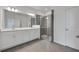 Bright bathroom with double sinks, quartz counters, and glass enclosed shower at 2860 Supermarine Rd, Tavares, FL 32778