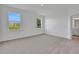 Bright bedroom with plush carpet, large windows and an ensuite bathroom at 2860 Supermarine Rd, Tavares, FL 32778