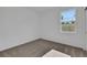 Bright bedroom with plush carpet and a window to the back yard at 2860 Supermarine Rd, Tavares, FL 32778