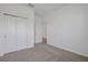 Clean bedroom with carpet flooring, double closet, and white trim at 2860 Supermarine Rd, Tavares, FL 32778