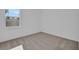Cozy bedroom with neutral carpet, a window with a view at 2860 Supermarine Rd, Tavares, FL 32778