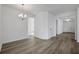 Open-concept dining room with modern lighting fixture and wood look floors at 2860 Supermarine Rd, Tavares, FL 32778