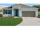 Charming single-story home with a well-manicured lawn and attached one car garage at 2860 Supermarine Rd, Tavares, FL 32778
