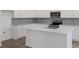 Bright, modern kitchen with a large island, stainless steel appliances, and white cabinets at 2860 Supermarine Rd, Tavares, FL 32778