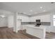 Modern kitchen featuring white cabinetry, stainless steel appliances, and center island with sink at 2860 Supermarine Rd, Tavares, FL 32778
