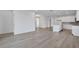 Open-concept living room with wood look floors and lots of natural light at 2860 Supermarine Rd, Tavares, FL 32778