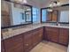 Bathroom vanity with granite countertops, double sinks, ample storage, and well-lit mirrors at 2918 Canyon Ave, The Villages, FL 32163
