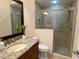 Bathroom featuring a vanity with granite countertop, a toilet, and a glass-enclosed shower at 2918 Canyon Ave, The Villages, FL 32163