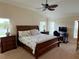 Cozy bedroom features a wooden bed frame and nautical-themed decor at 2918 Canyon Ave, The Villages, FL 32163