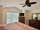 Bedroom featuring a dark wooden dresser, crown molding, and large window at 2918 Canyon Ave, The Villages, FL 32163