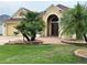 Inviting home with lush landscaping, a brick walkway, and a double-door entry at 2918 Canyon Ave, The Villages, FL 32163