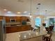 Kitchen with stainless steel appliances and a breakfast bar overlooking the dining area at 2918 Canyon Ave, The Villages, FL 32163