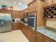 Kitchen with custom cabinets, granite countertops, and stainless steel appliances at 2918 Canyon Ave, The Villages, FL 32163