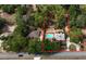 Expansive aerial view showcasing the property's layout, mature trees, pool, buildings, and defining boundaries at 308 Sunnyside Dr, Leesburg, FL 34748