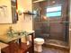 Updated bathroom with glass bowl sink and a spacious glass enclosed shower at 308 Sunnyside Dr, Leesburg, FL 34748