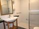 Bathroom sink with modern fixtures, a wooden vanity, and a glass enclosed shower at 308 Sunnyside Dr, Leesburg, FL 34748