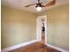 Bedroom featuring a ceiling fan, hardwood floors, and doorway to the rest of the house at 308 Sunnyside Dr, Leesburg, FL 34748