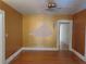 Cozy bedroom featuring warm-toned walls, wood flooring, and ceiling fan at 308 Sunnyside Dr, Leesburg, FL 34748