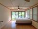 Bedroom with sliding glass doors to the outside area and natural light at 308 Sunnyside Dr, Leesburg, FL 34748