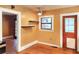 Dining room with floating shelves, rustic floors, light-filled windows, and a ceiling fan at 308 Sunnyside Dr, Leesburg, FL 34748