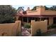 Charming home featuring a stucco exterior, a red tile roof, and a gated entrance with a brick walkway at 308 Sunnyside Dr, Leesburg, FL 34748