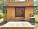 Exterior of home showing deck and access to interior room with AC unit at 308 Sunnyside Dr, Leesburg, FL 34748