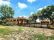Property with well-maintained fence and outdoor swimming pool, trees and blue sky backdrop at 308 Sunnyside Dr, Leesburg, FL 34748