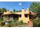 Charming home with red tile roof, screened porch, and lush greenery at 308 Sunnyside Dr, Leesburg, FL 34748