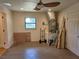 Spacious garage offering ample room for storage and projects, window, and entry door at 308 Sunnyside Dr, Leesburg, FL 34748