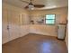 Attached garage featuring a ceiling fan, pegboard, storage, and a utility sink at 308 Sunnyside Dr, Leesburg, FL 34748